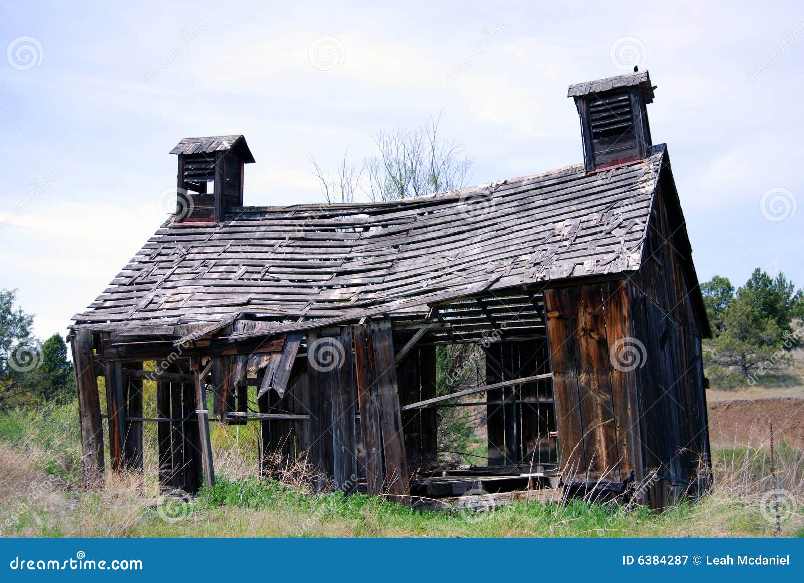 Horizontal image of a derelict 1900's barn in ruins, in Oregon, USA.