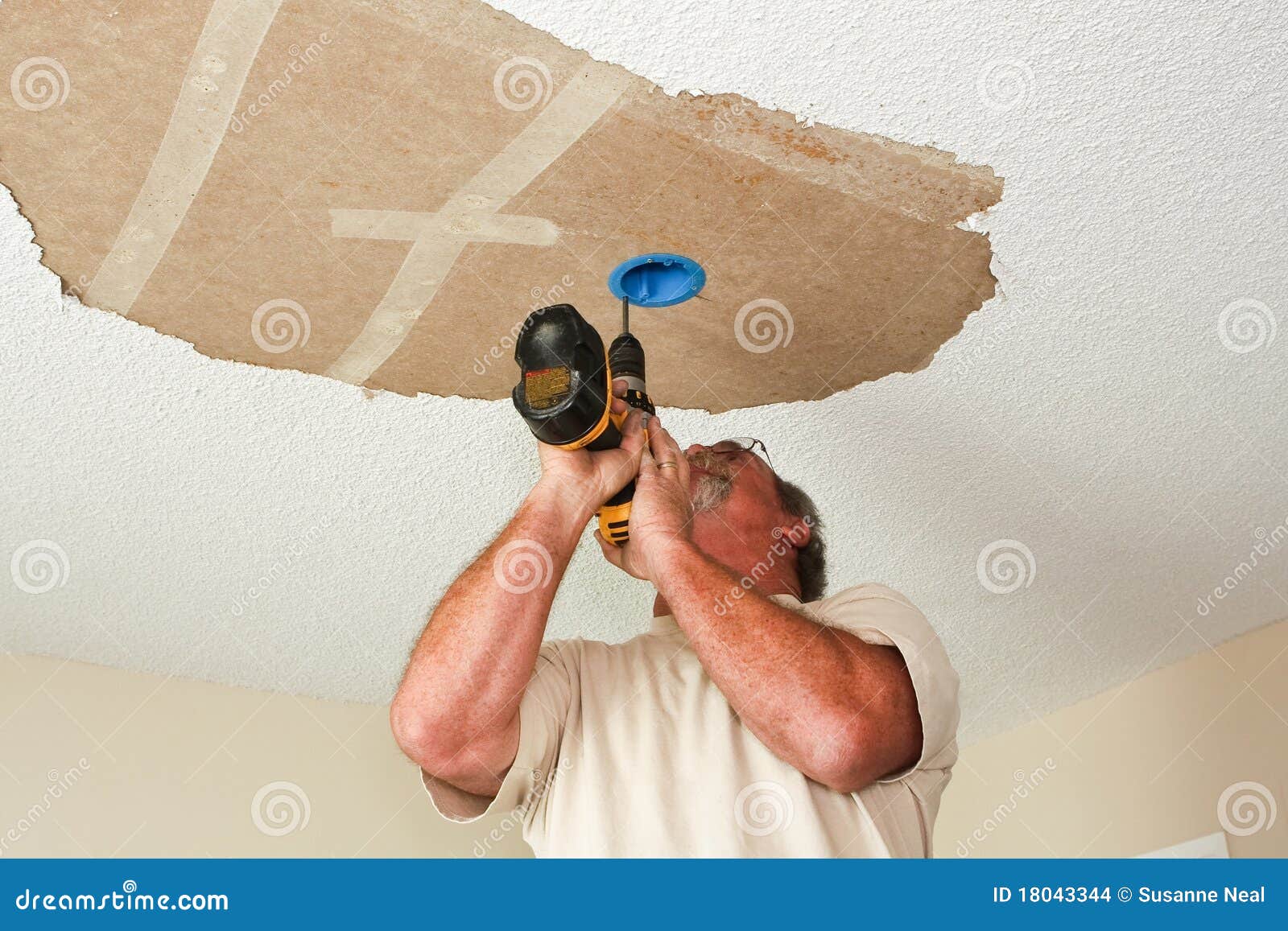 Electrician Installing Light Fixture On Ceiling Stock Images - Image