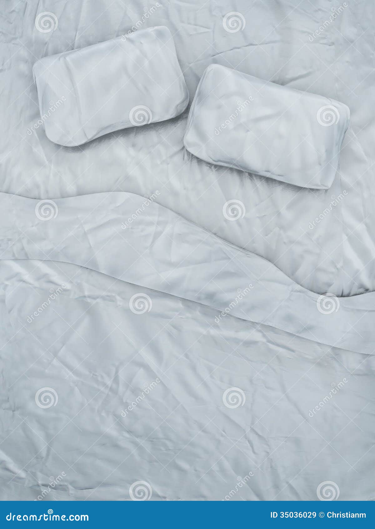 Top view of an empty bed with white sheets and a pair of pillows.