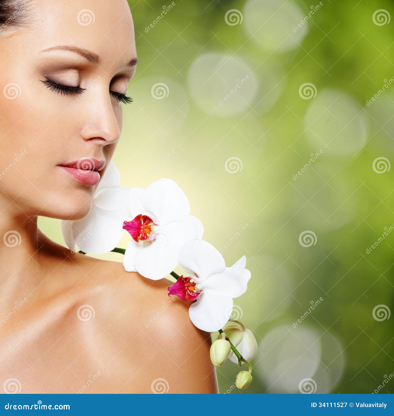 Face of beautiful woman with a <b>white orchid</b> flower - face-beautiful-woman-white-orchid-flower-beauty-skin-care-treatment-green-nature-background-34111527