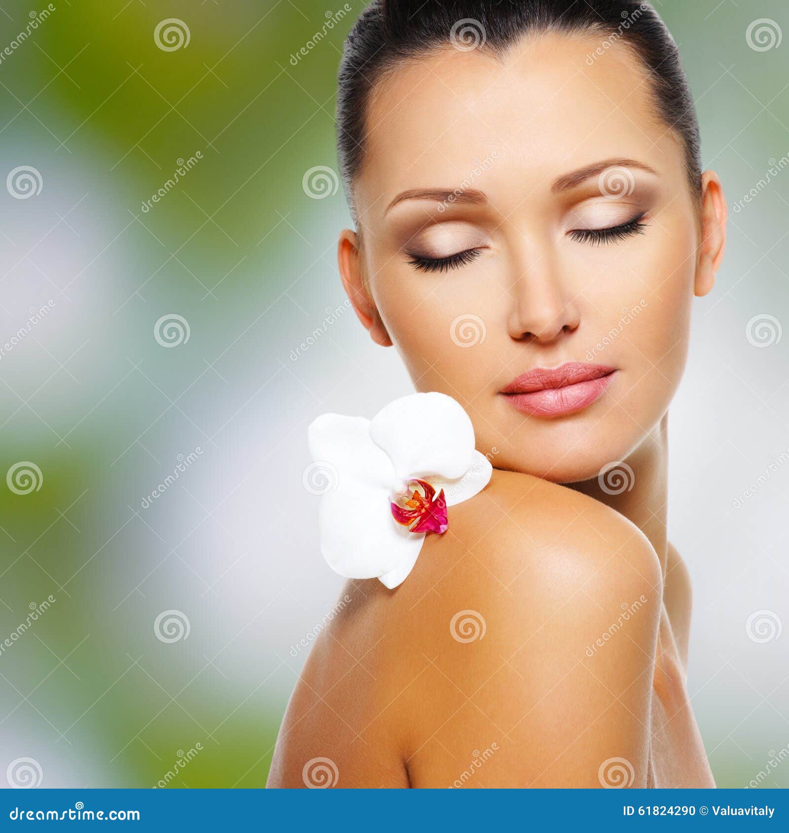 Face of beautiful woman with a <b>white orchid</b> flower - face-beautiful-woman-white-orchid-flower-beauty-skin-care-treatment-green-nature-background-61824290
