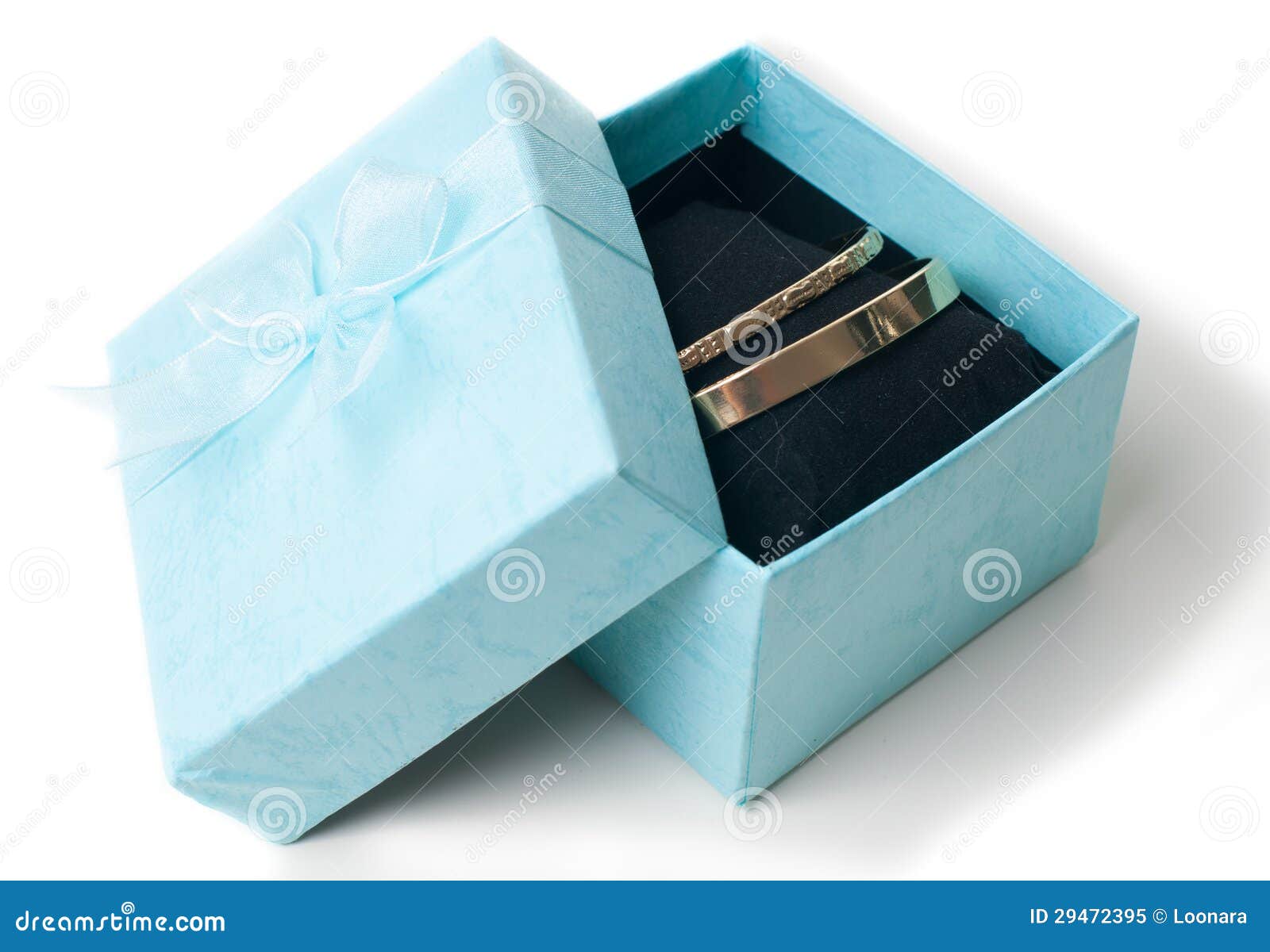 Fashion jewelry, two women's golden bracelets in opened gift box ...