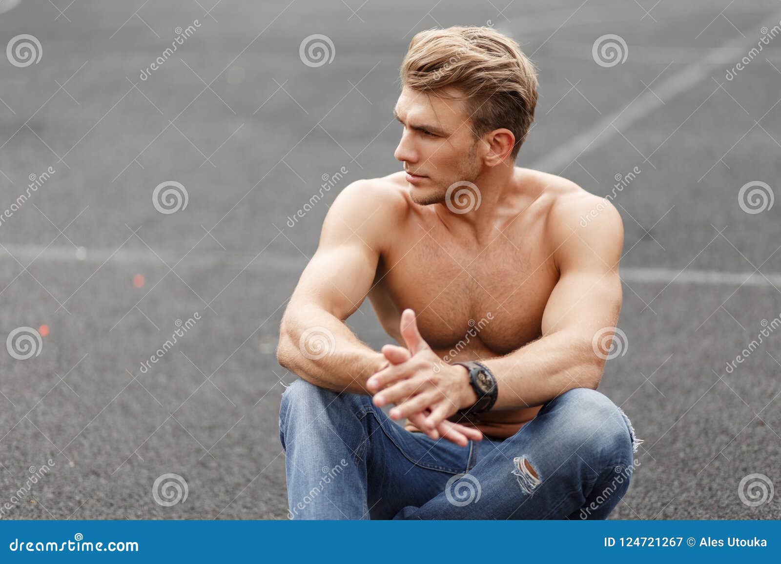 Fashionable Man With Hairstyle With A Fitness Naked Torso Sits Stock