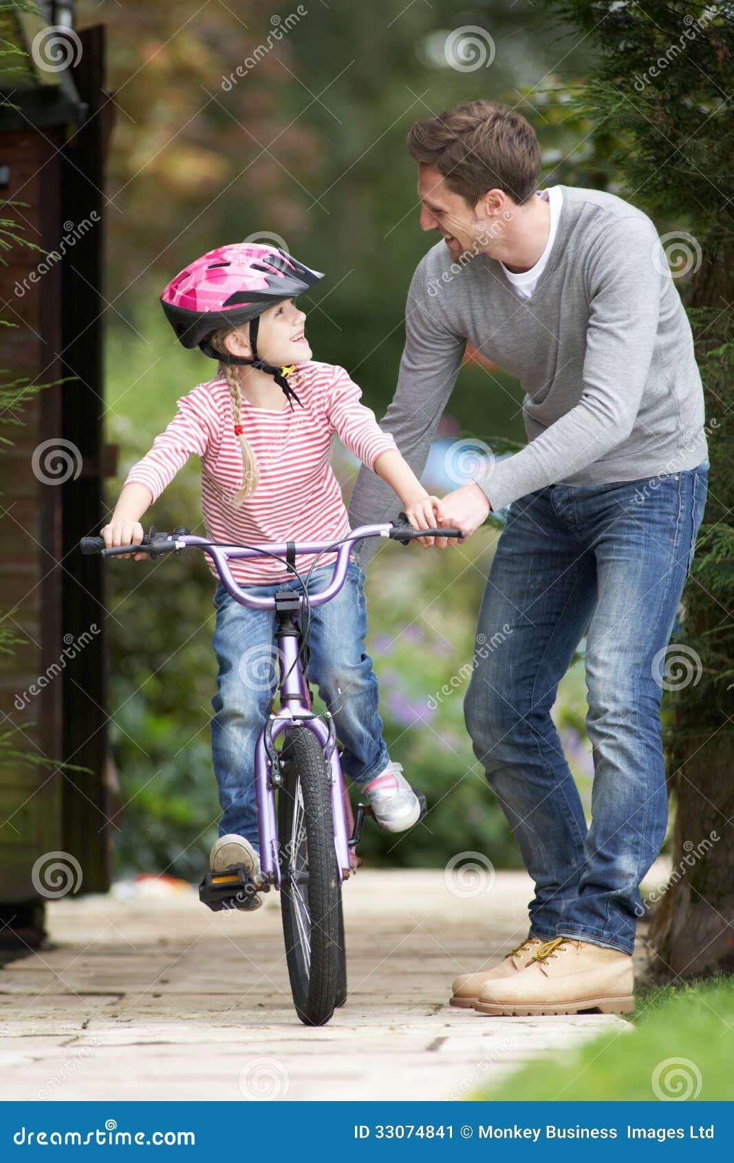 Father Teaching Daughter To Ride Bike In Garden Stock Image Image 33074841