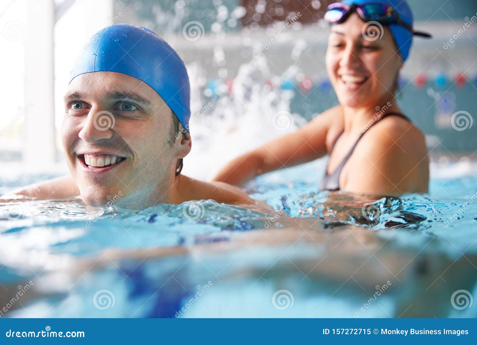 Female Swimming Teacher Giving Man One To One Lesson In Pool Stock Photo Cartoondealer