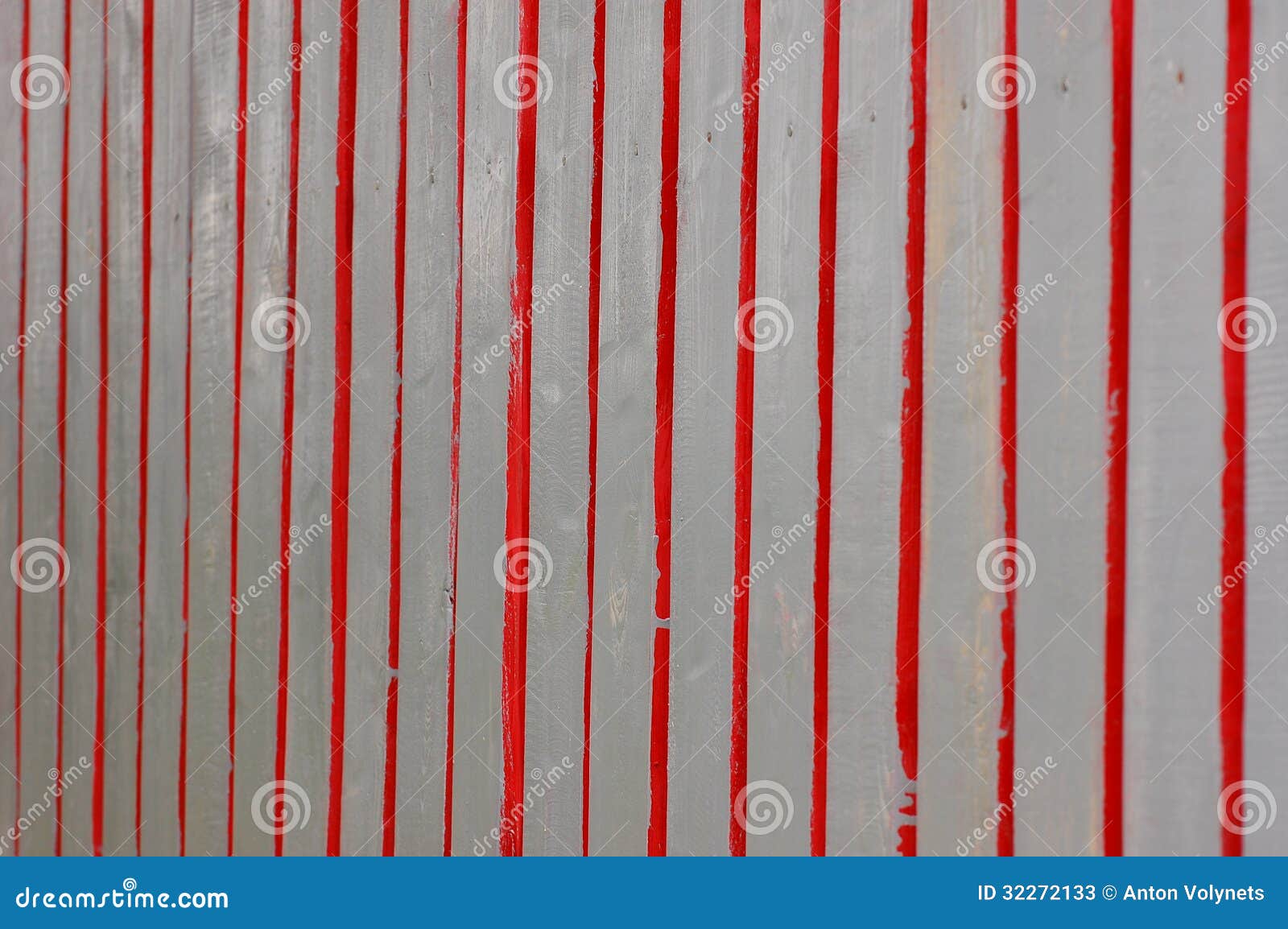 Wooden fence painted in red and gray colors.
