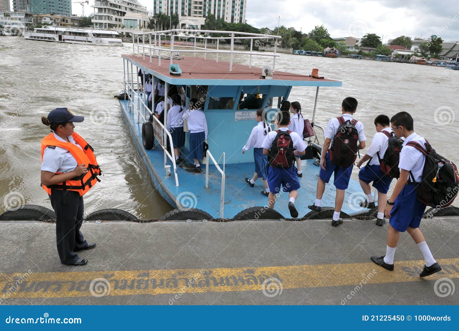 School children board a boat to cross the Chao Phraya River on 