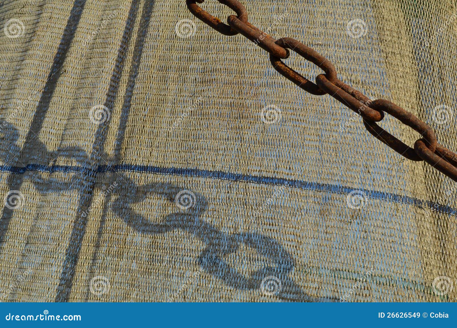 Fishing gear of a danish shrimp boat. Shadow of a rusty chain on ...