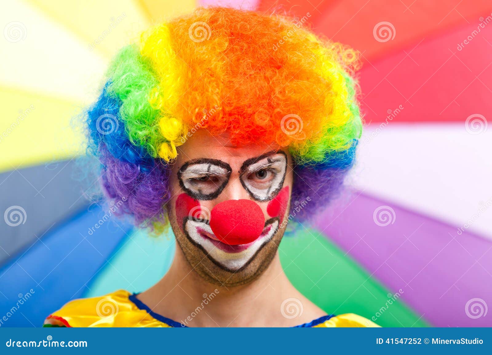 Funny clown face on a colorful background.