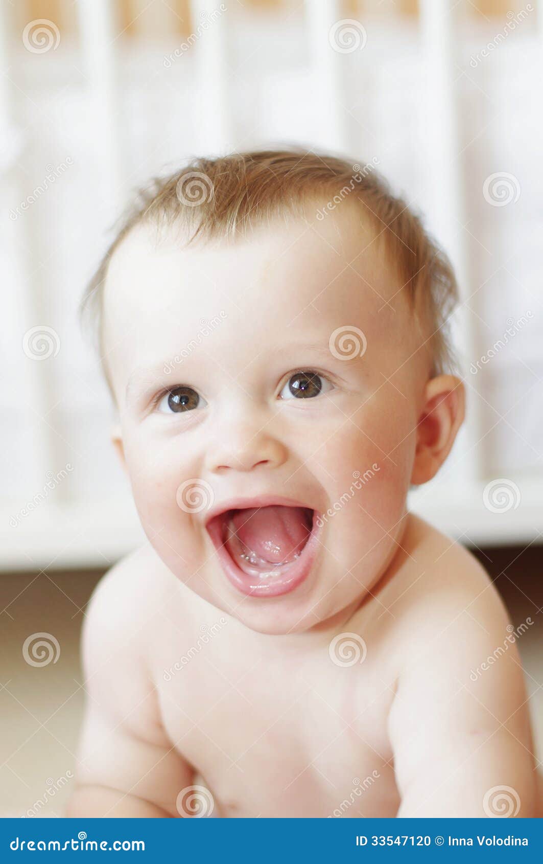 Download this Funny Babies Laughing Baby Against White Bed picture