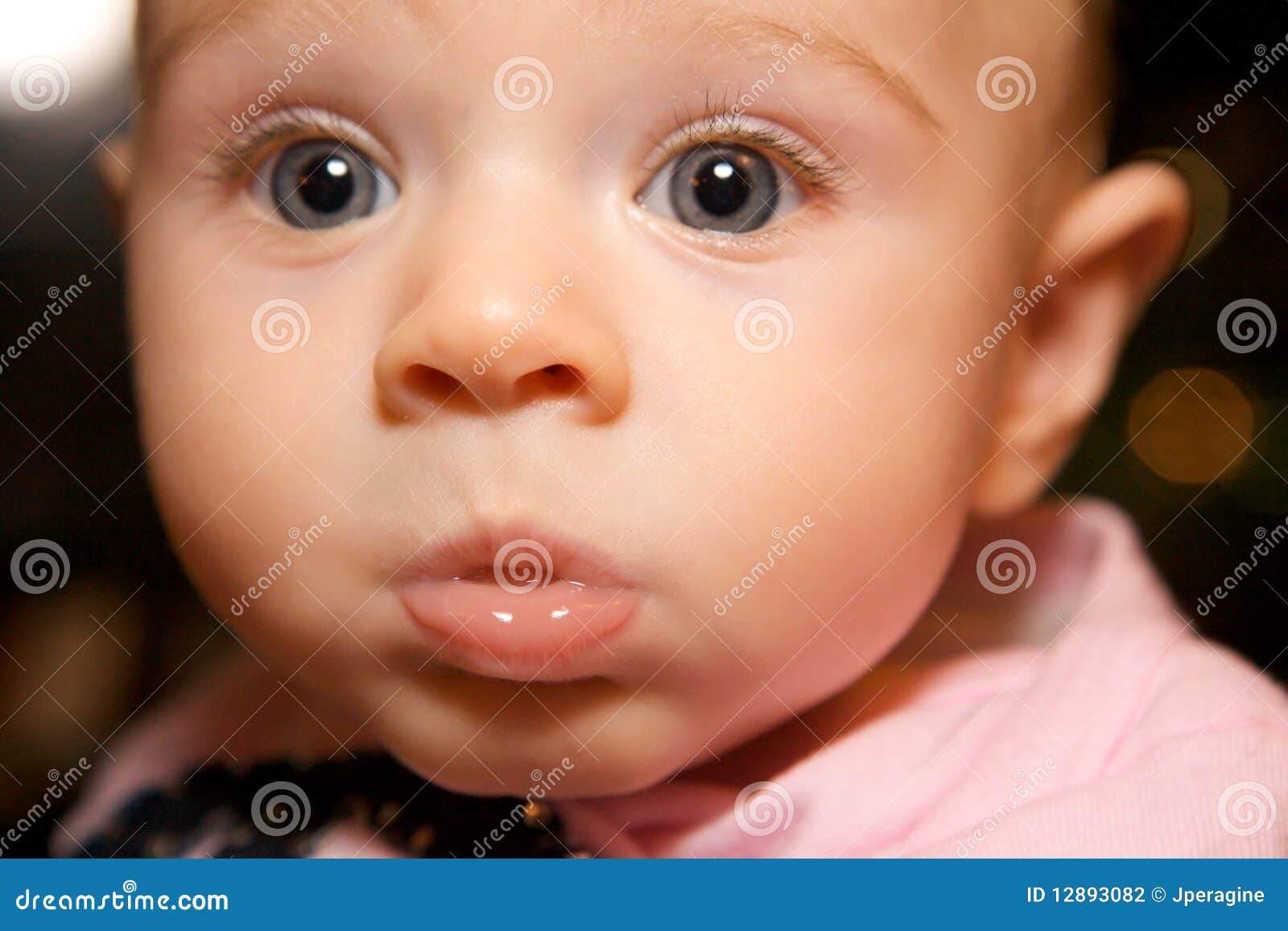 Funny Little Girl Making Cute Face with big puffy cheecks.