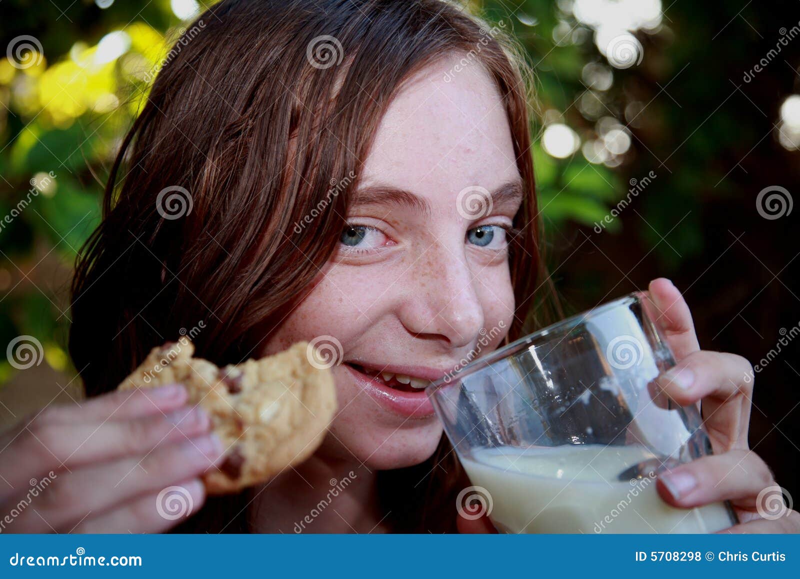 Girl eating cookies and milk - girl-eating-cookies-milk-5708298