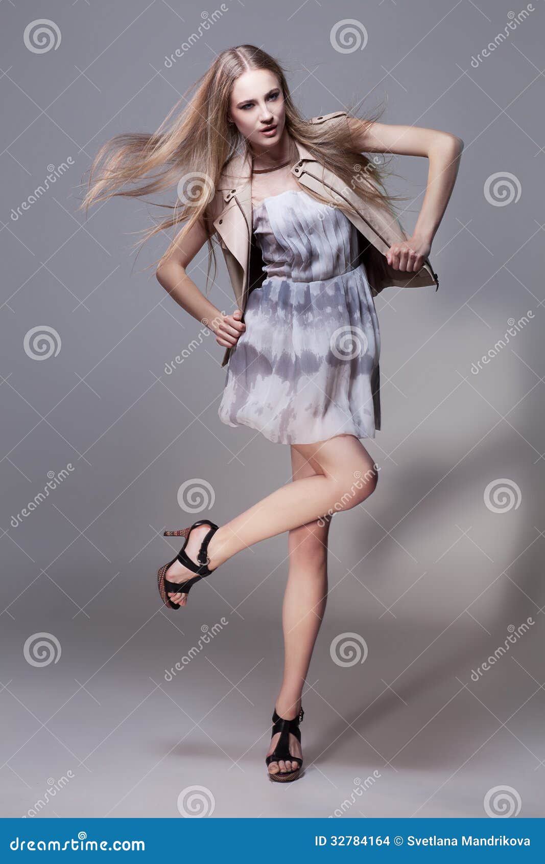 ... girl with flying hair in fashionable short dress and waistcoat