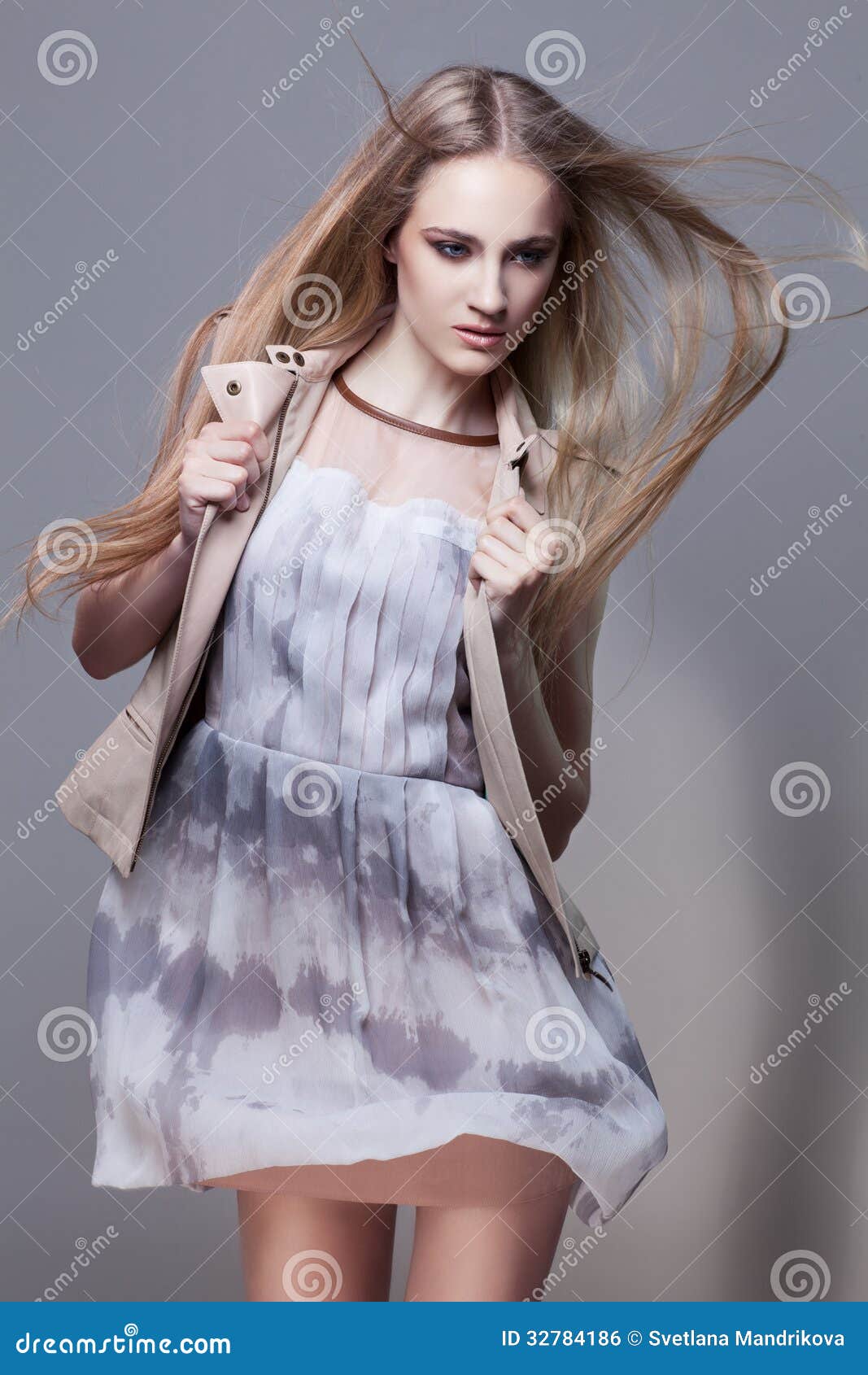 ... girl with flying hair in fashionable short dress and waistcoat