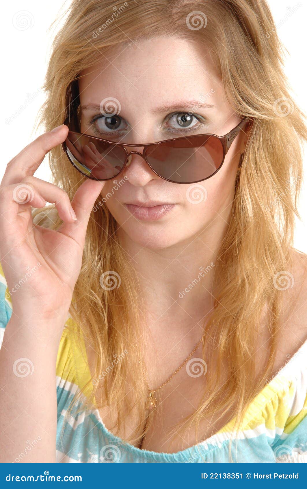 Of blond teen holding sunglasses