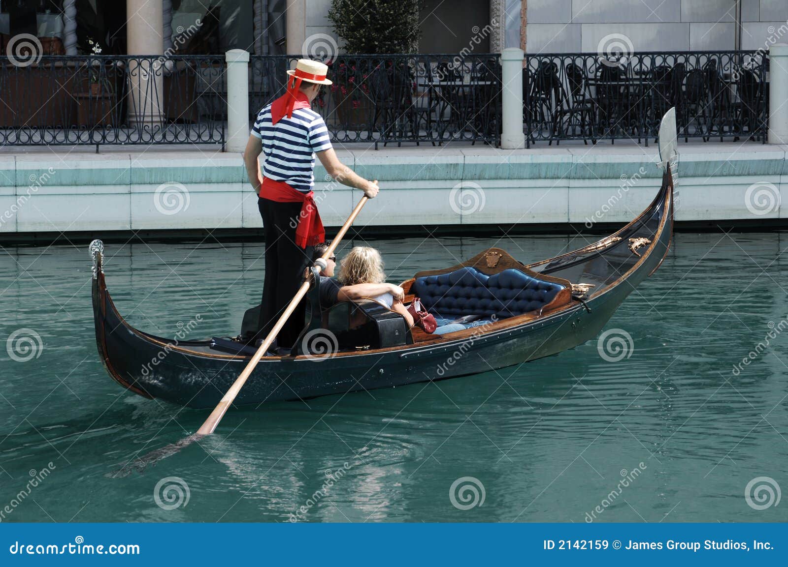 Couple having a romantic ride down a canal in a gondola.