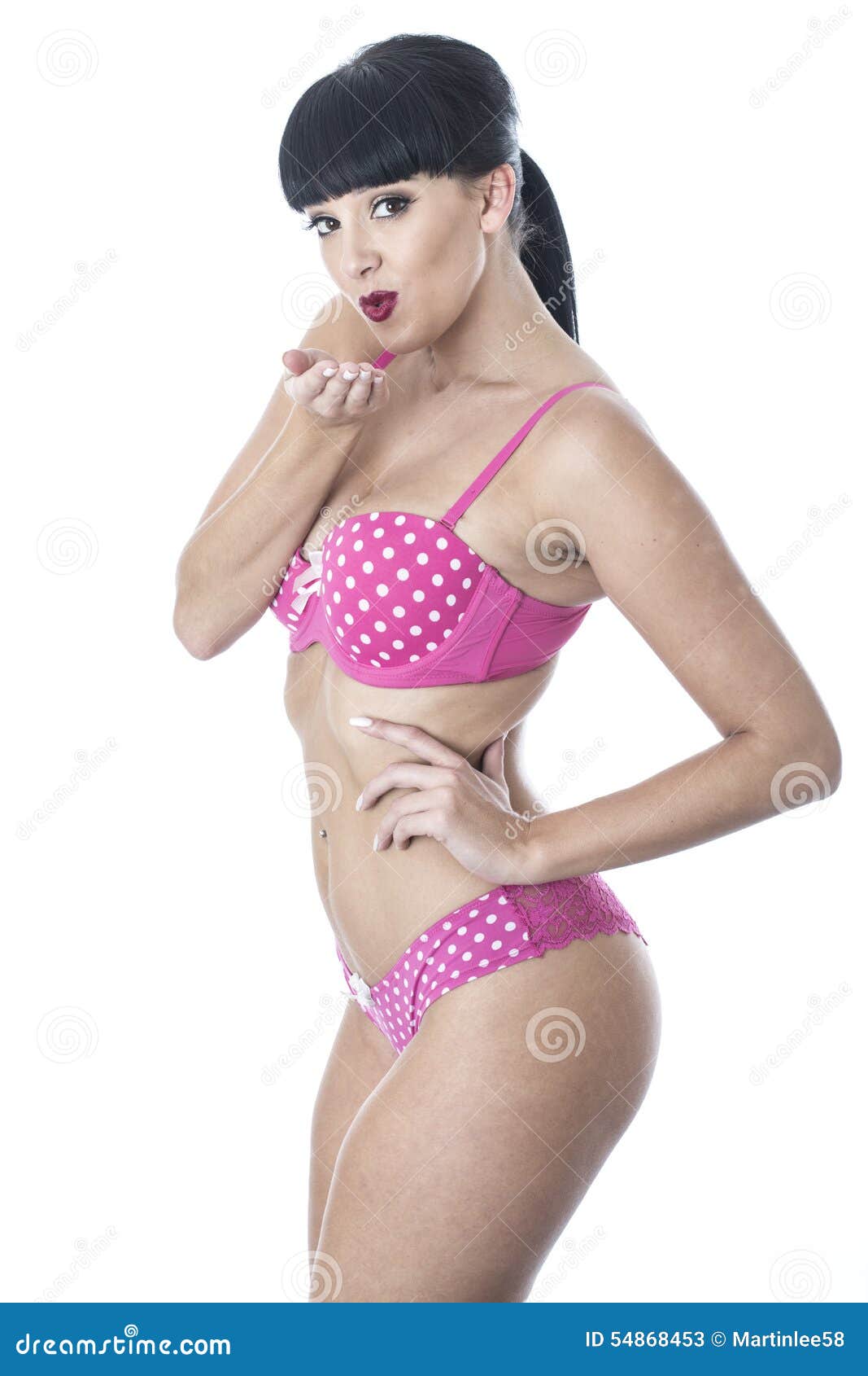 Gorgeous Sexy Cute Glamorous Pin Up Model Posing In Pink Polka Dot Lingerie Blowing Kisses Stock