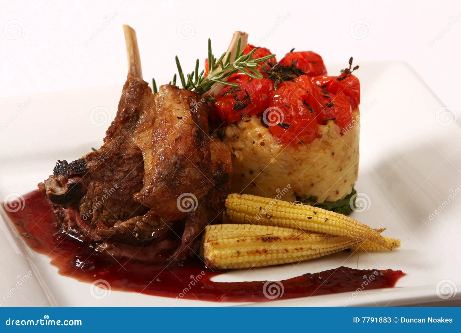 Scrumptuous meal of lamb chops,rice cake and vegetables.