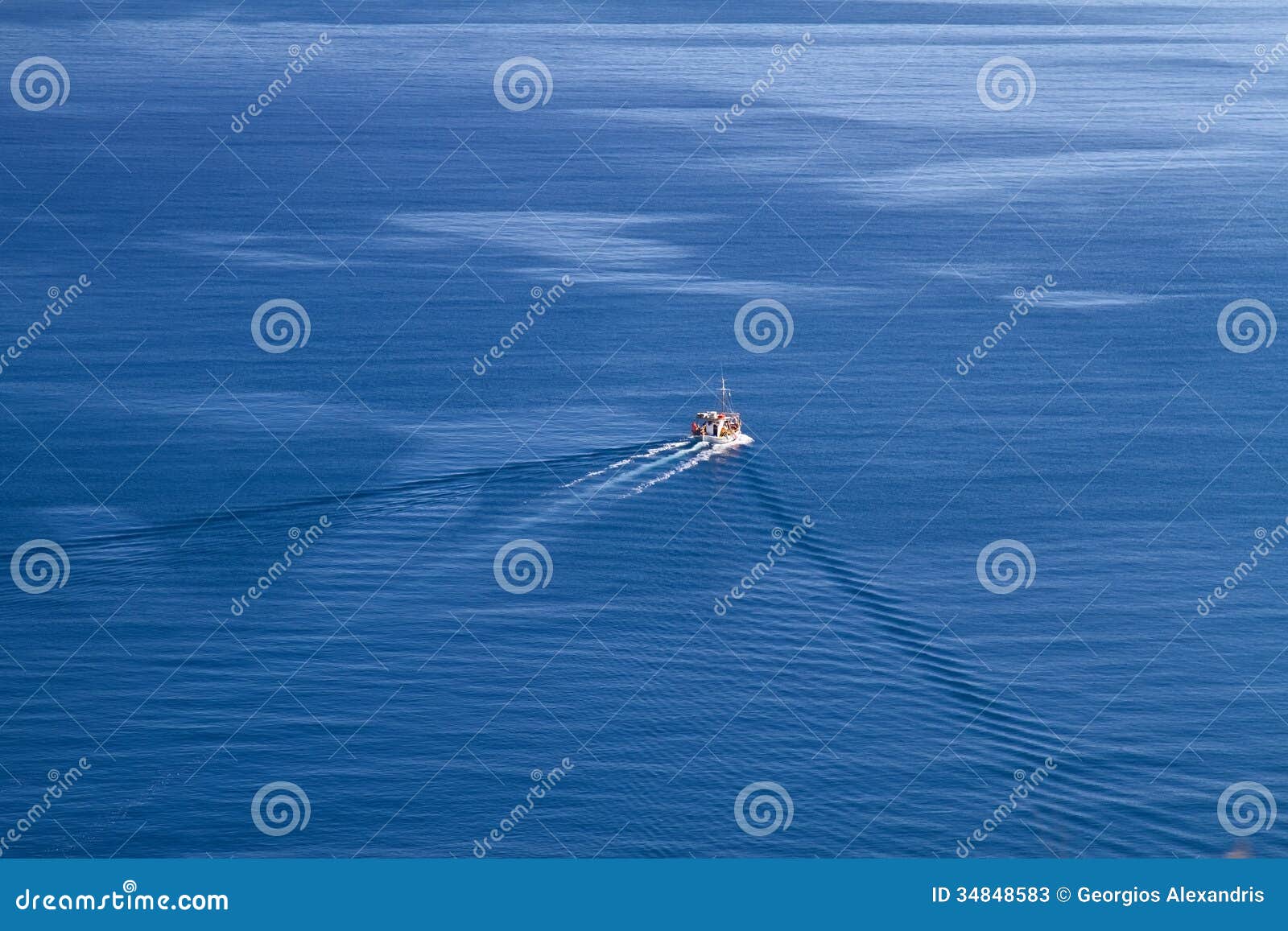 fishing boat travelling in the deep-blue waters of Aegean sea 