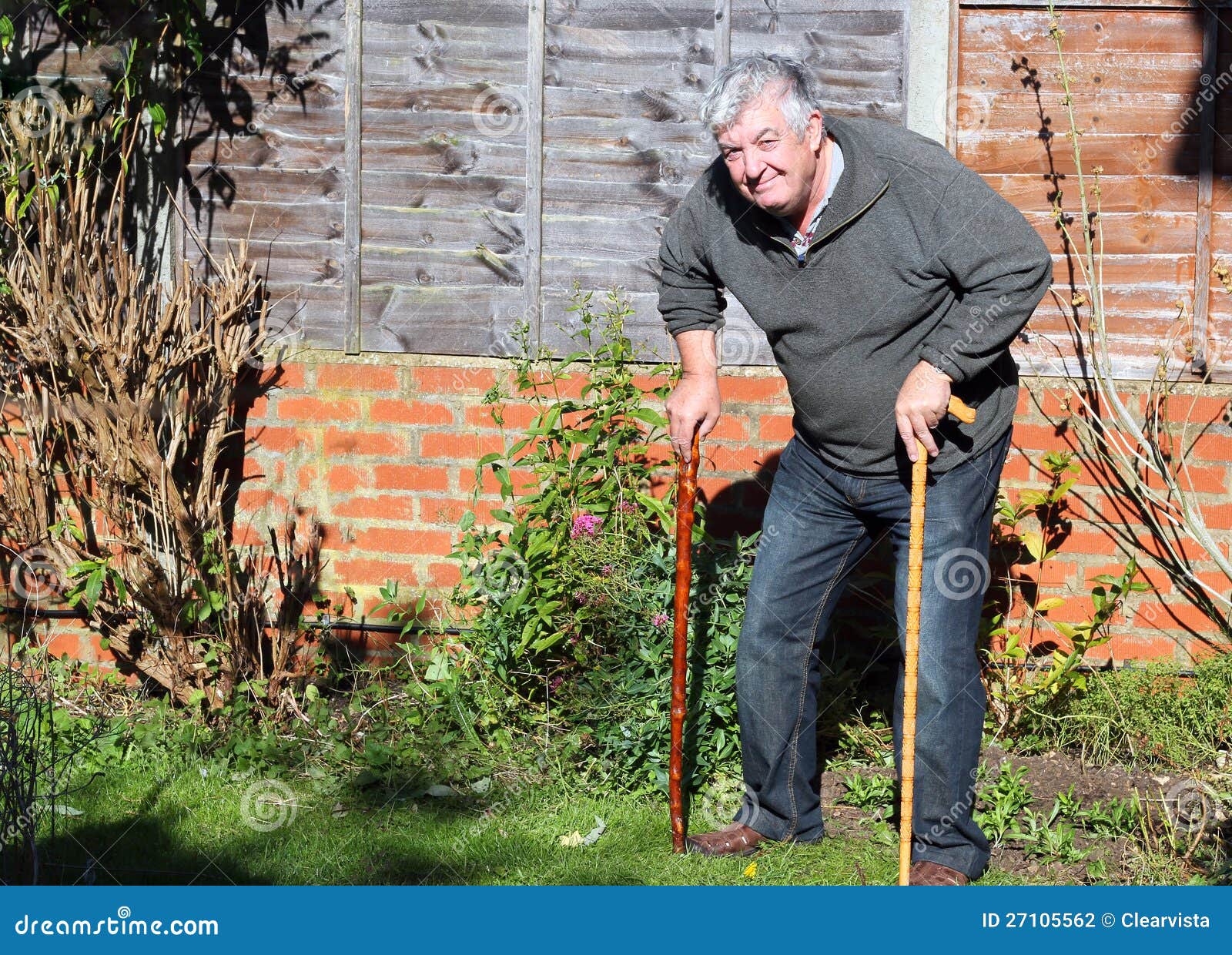 happy-elderly-man-two-walking-sticks-27105562.jpg