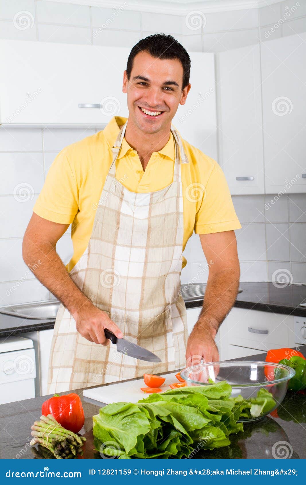 happy-man-cooking-12821159.jpg