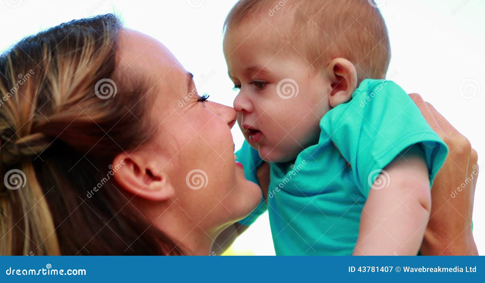 Happy Mother Rubbing Noses With Cute Baby Son In The Park Stock Video