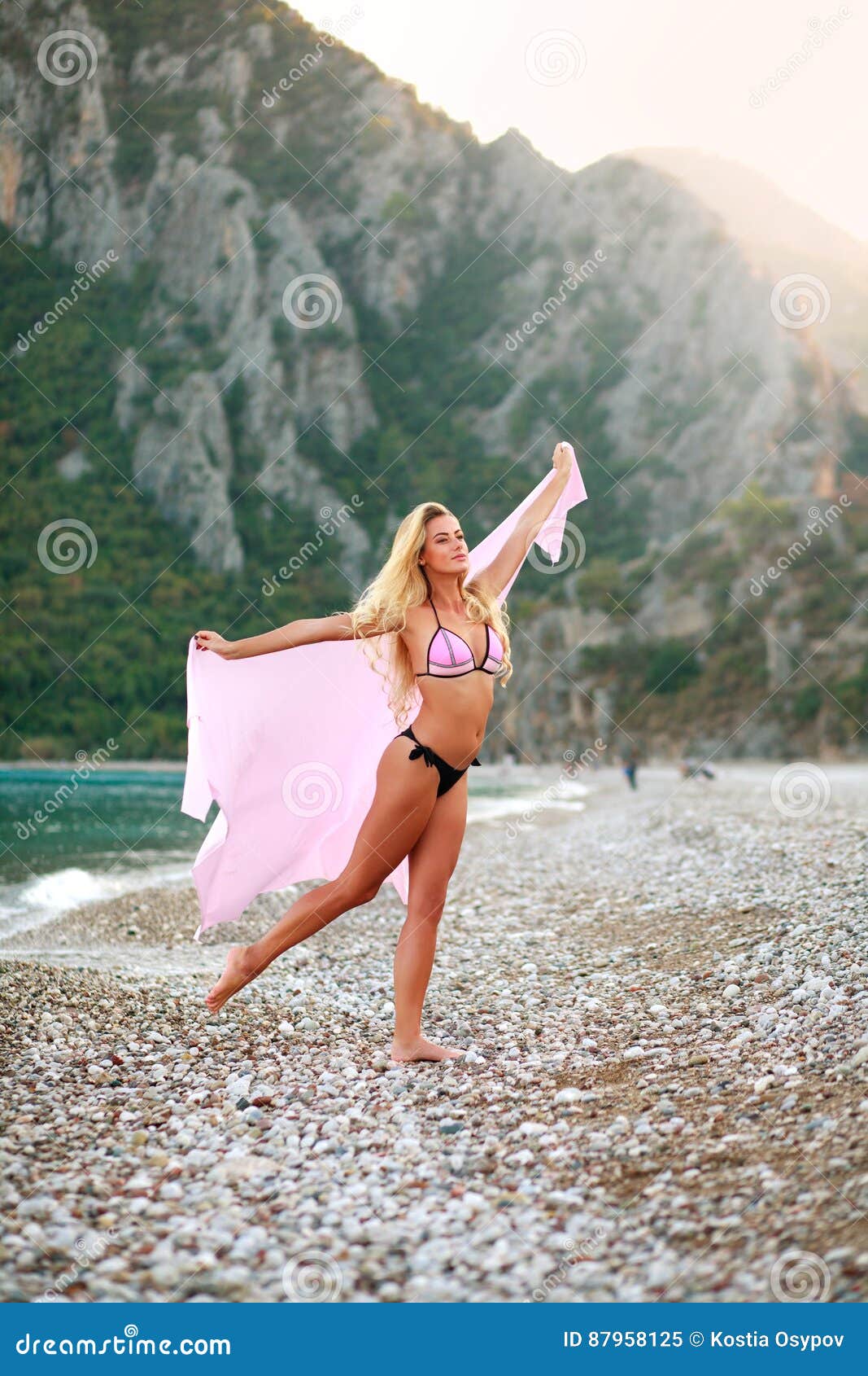 Happy Playful Woman On Sea Beach On Background Of Mountains Stock Image