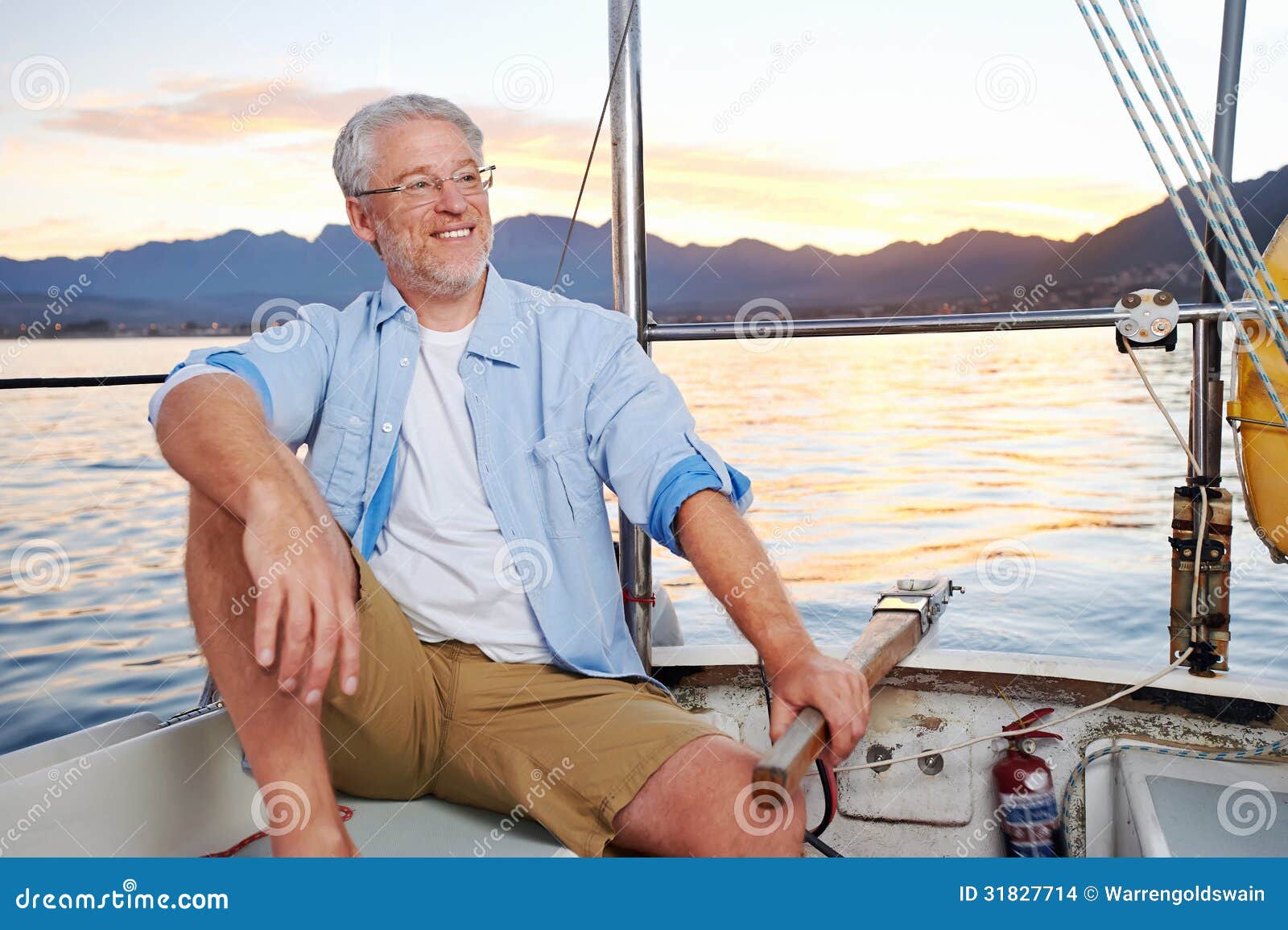  sailing man portrait of mature retired man on ocean boat at sunrise