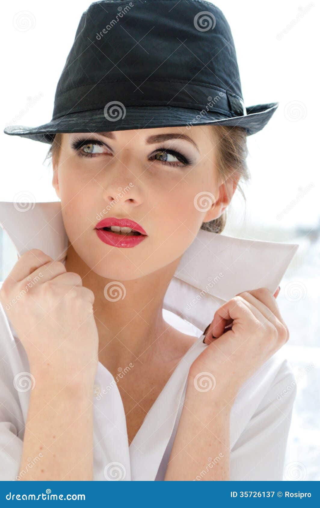 headshot-young-business-woman-wearing-man-s-shirt-hat-looking-bossy-stylish-office-white-background-35726137.jpg