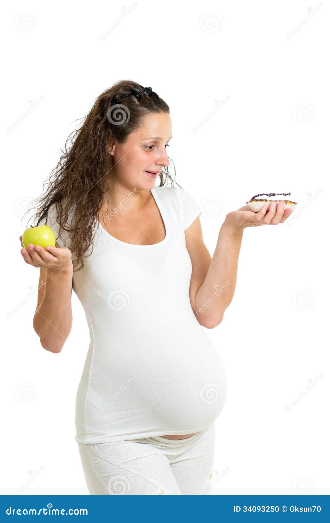 Healthy food concept for pregnancy. Woman choosing between cake and ...