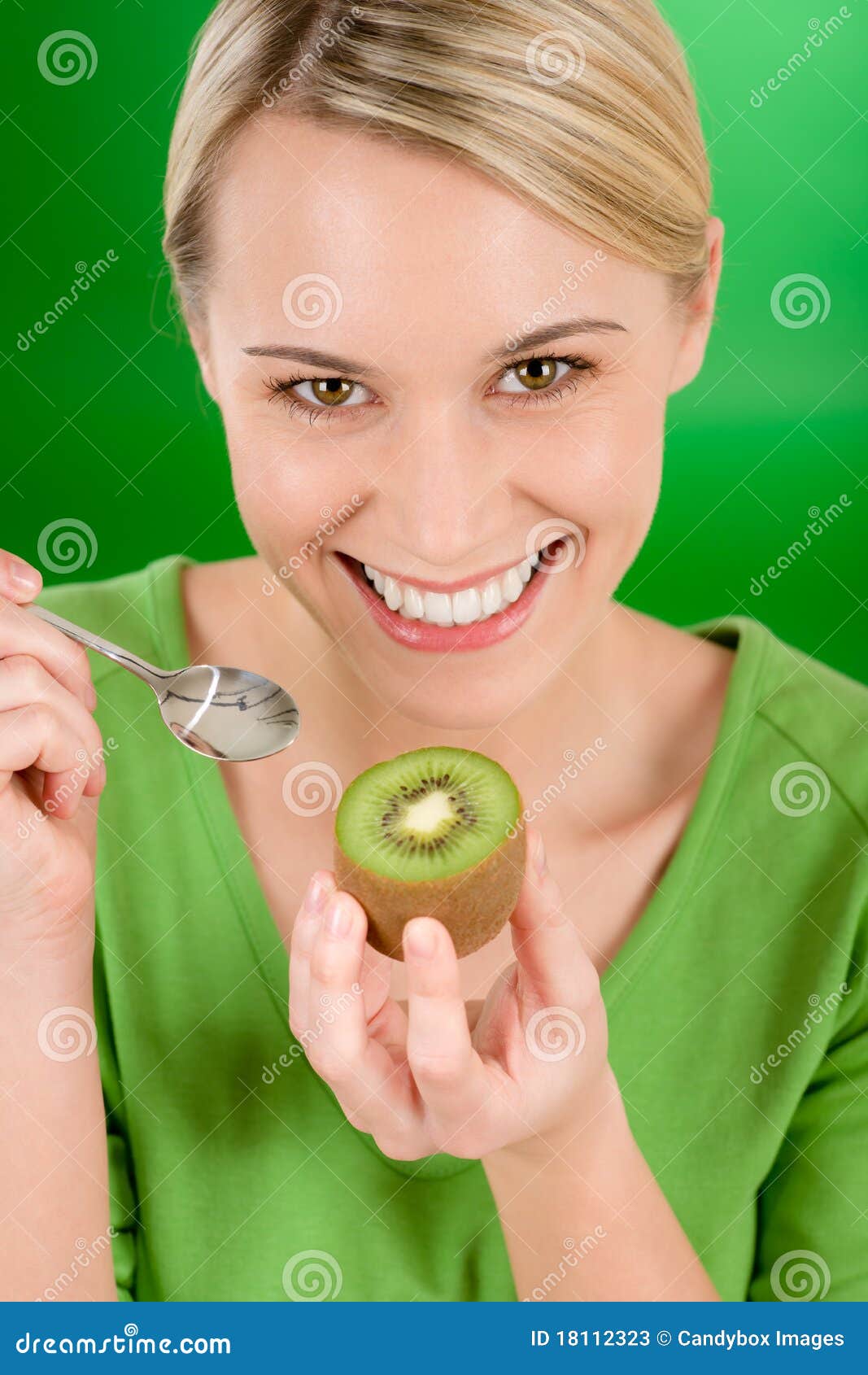 Healthy lifestyle - happy woman holding kiwi and teaspoon on green ...