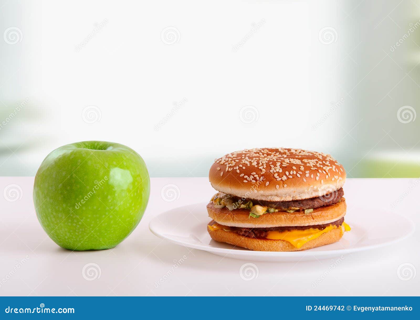 Choice of healthy and unhealthy food. Diet concept: green apple and ...
