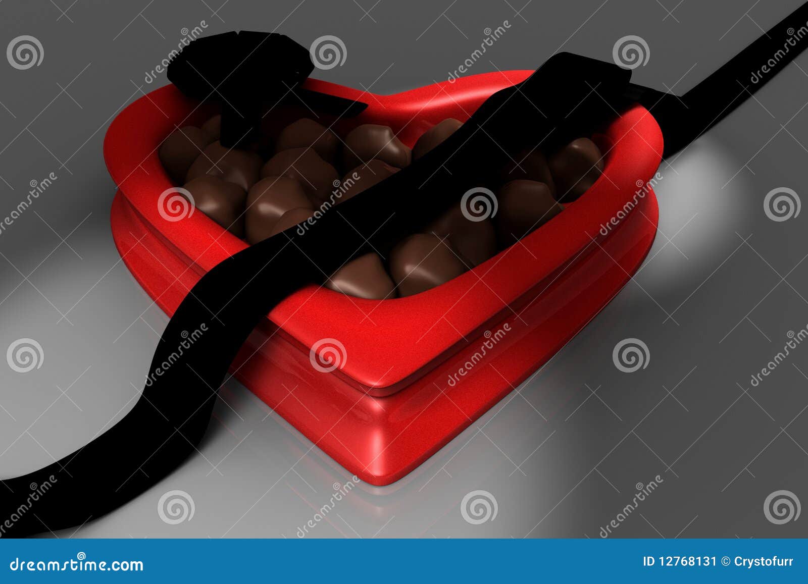 Red heart shaped box of chocolates on hard wood surface with a white 