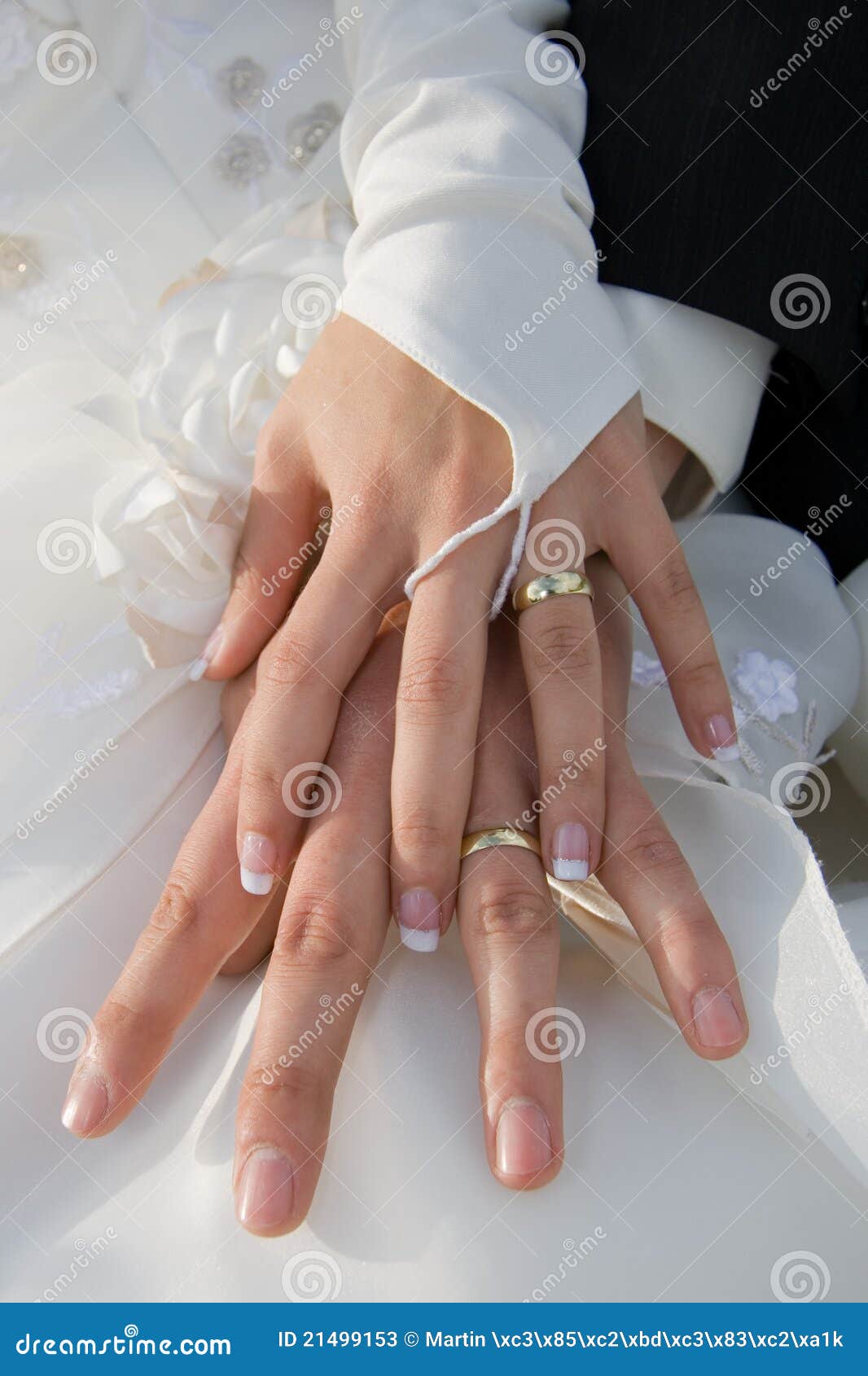 Couple is holding their hands together and showing off their rings ...