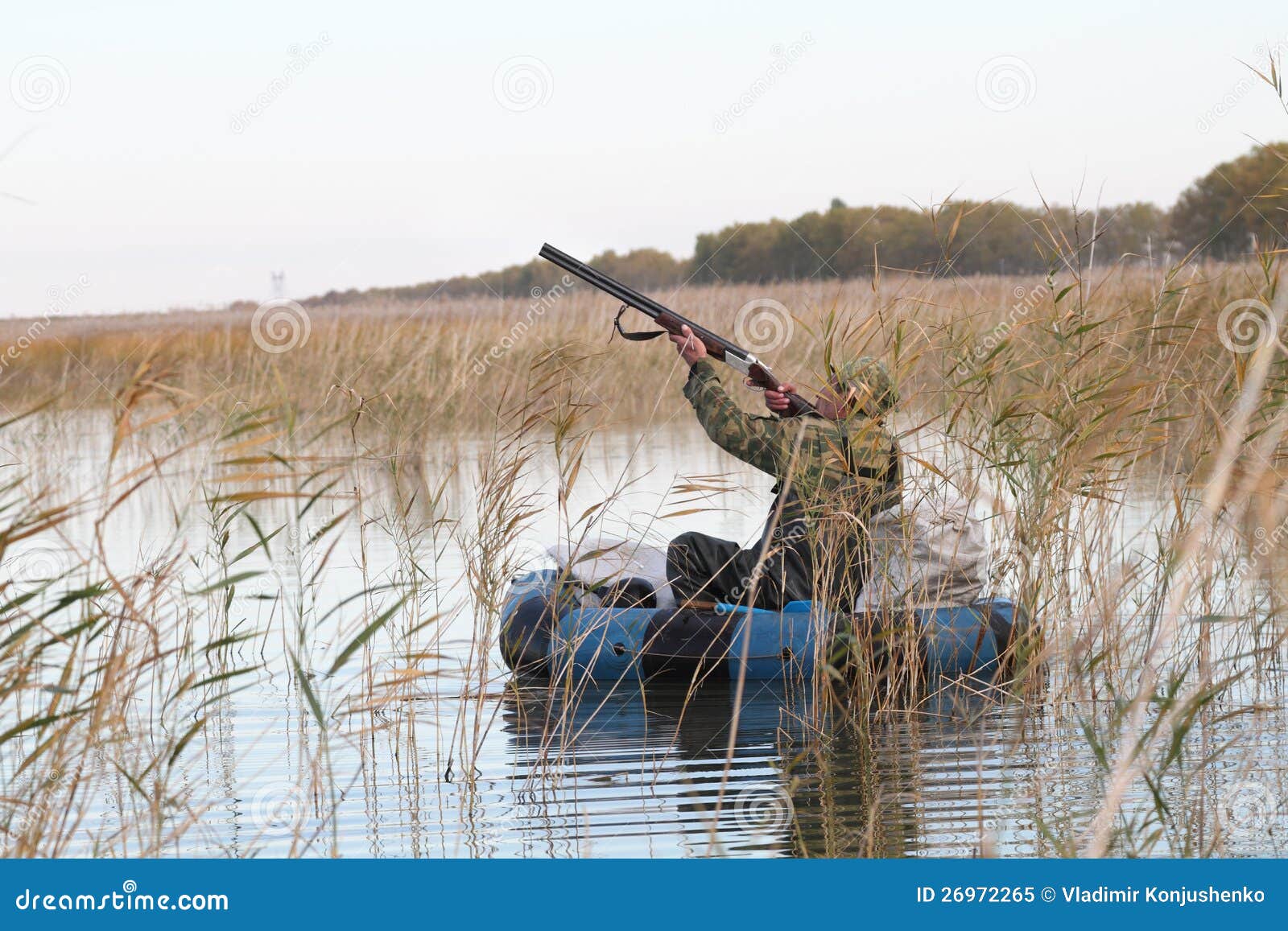 Royalty Free Stock Photo: Hunter in a boat