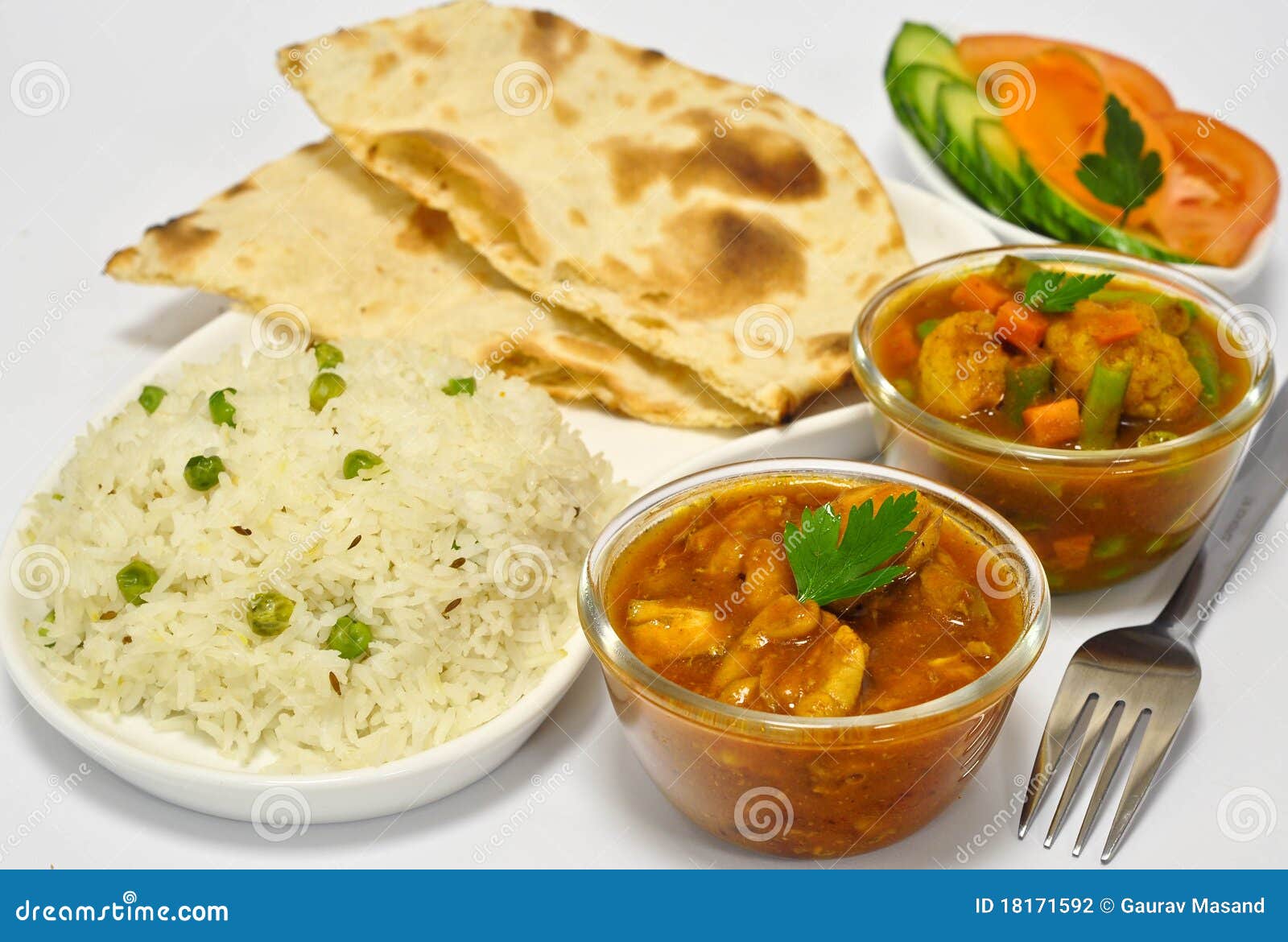 Indian meal consisting of chicken curry as the main dish, along with 