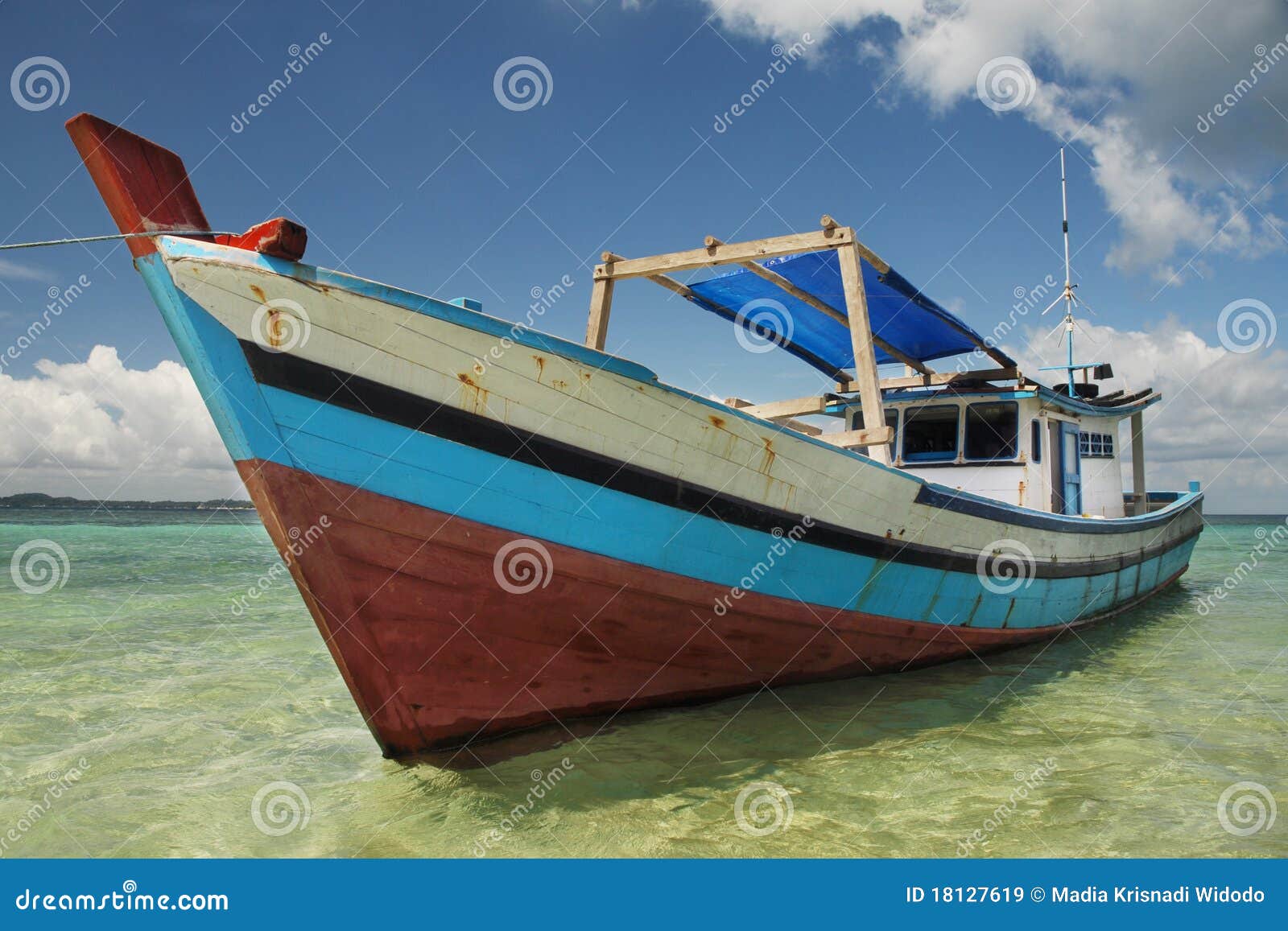 colorful wooden boat moored on a beach at Belitung Island, Indonesia 