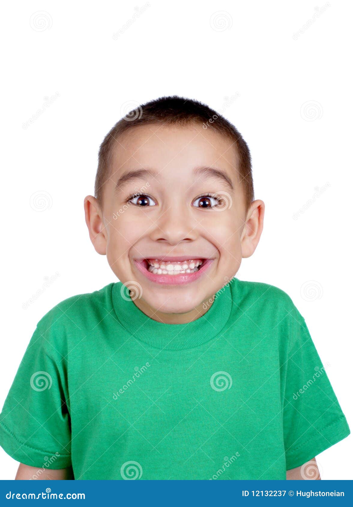 Six-year-old boy making a silly face, with a big toothy smile ...