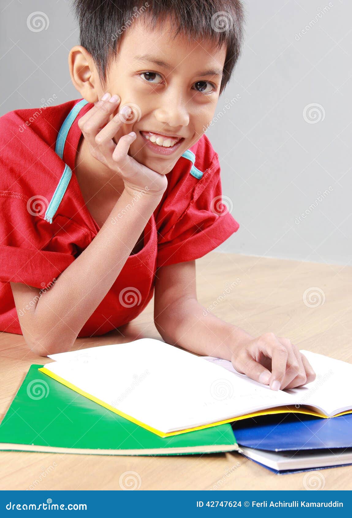 Kid reading book on the floor - kid-reading-book-floor-portrait-happy-lay-down-42747624