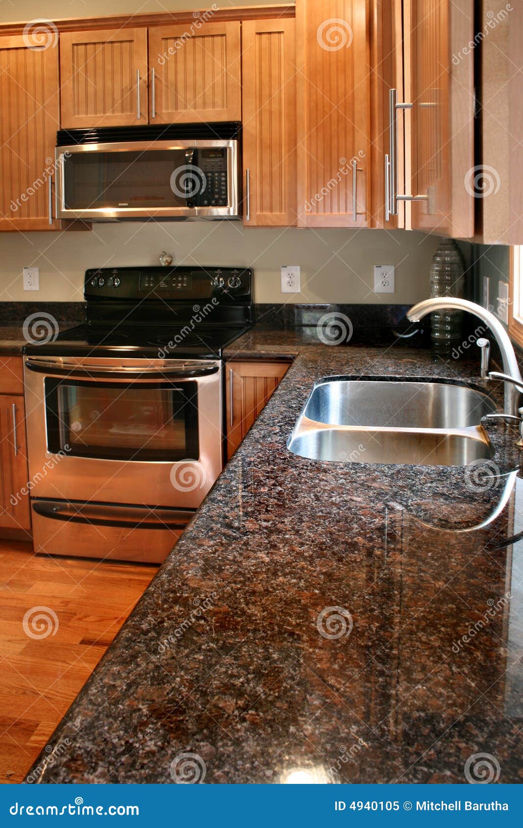 New kitchen with wood cabinets, black and stainless steel stove and 