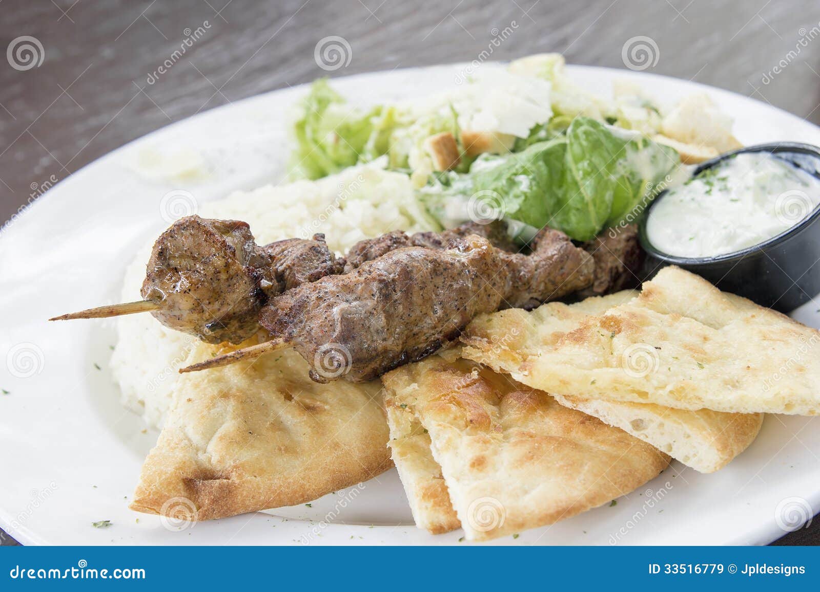 Lamb Kebab Skewers with Basmati Rice Naan Bread and Salad Closeup.