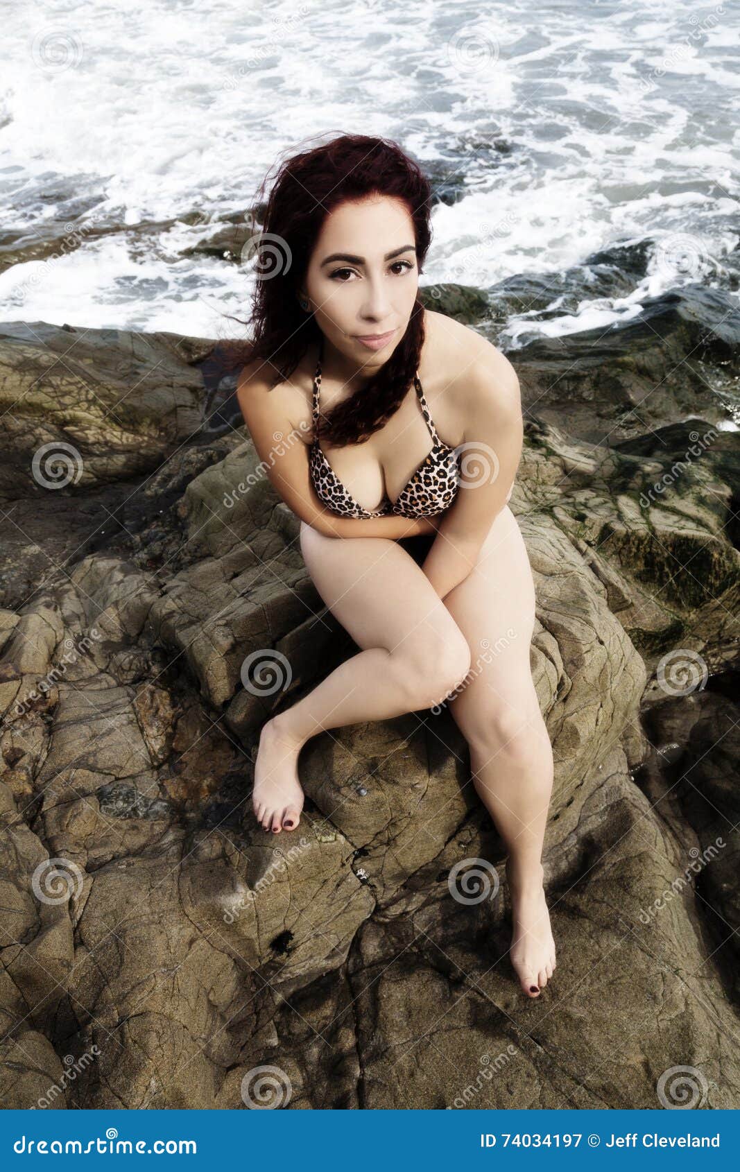 Latina Woman Sitting On Rocks In Bikini With Ocean Behind Her Stock 58960 Hot Sex Picture picture pic
