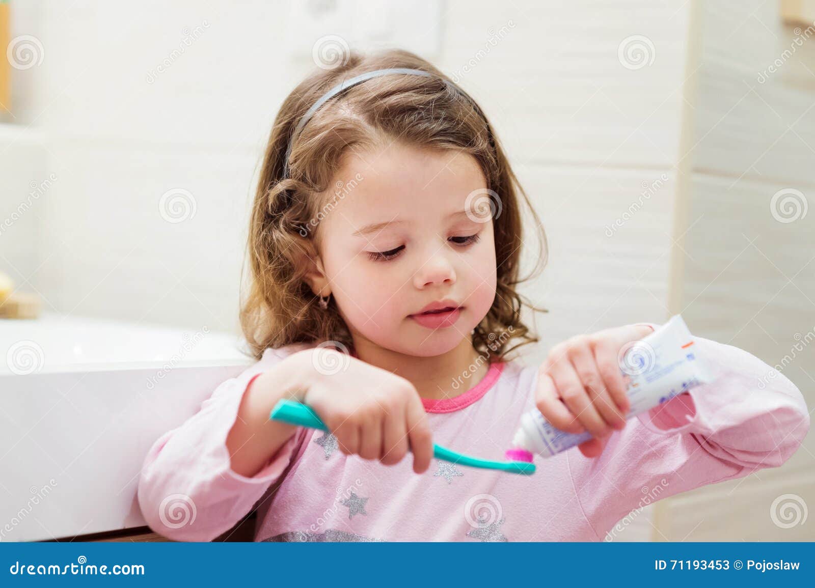 Little Girl In Bathroom Putting A Toothpaste On Toothbrush Stock Photo Little Girl In Bathroom Putting A Toothpaste On Toothbrush Stock Photo