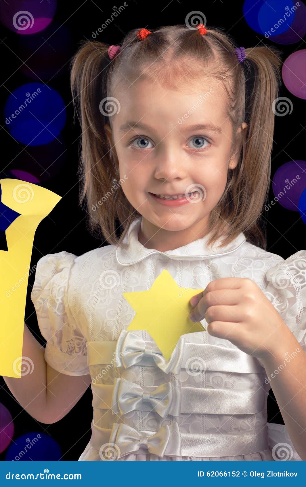 Little girl happy cutting paper figures for Christmas against black background with blurred lights - little-girl-happy-cutting-paper-figures-christmas-against-black-background-blurred-lights-color-62066152