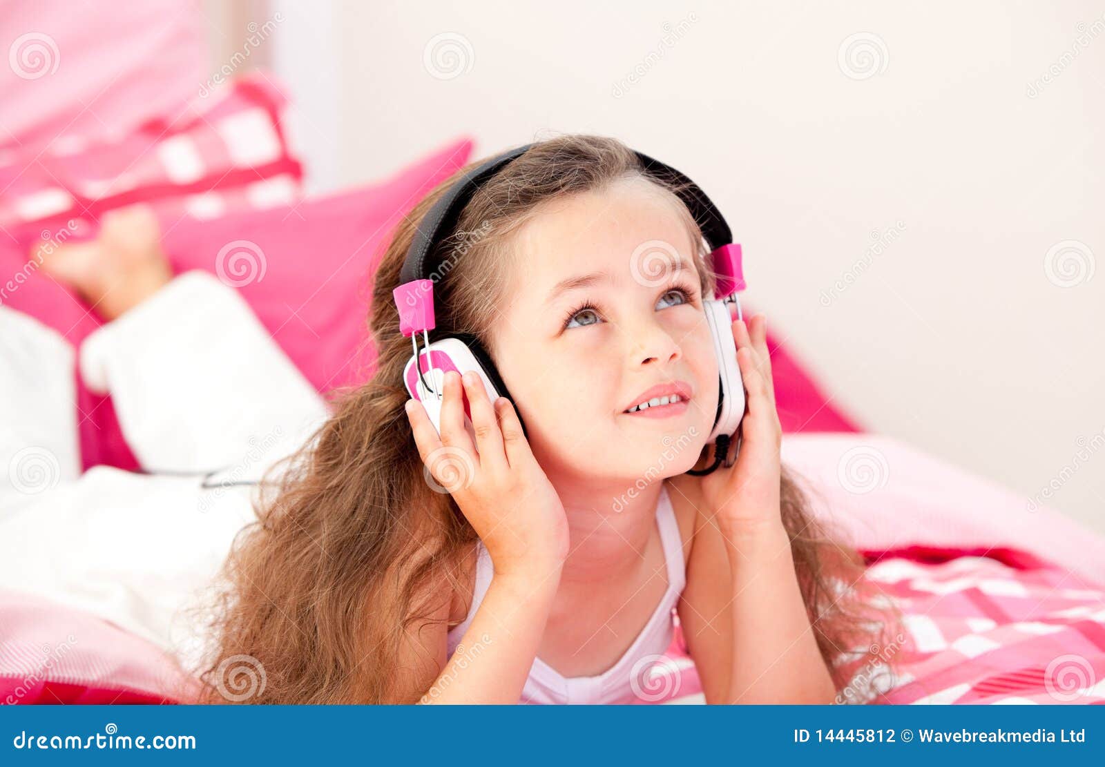 little-girl-listening-music-headphones-14445812.jpg