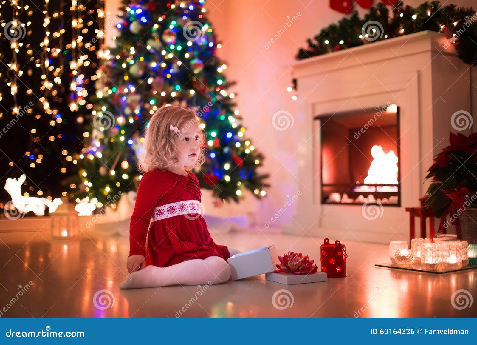 Little Girl Opening Christmas Presents At Fire Place Stock ...