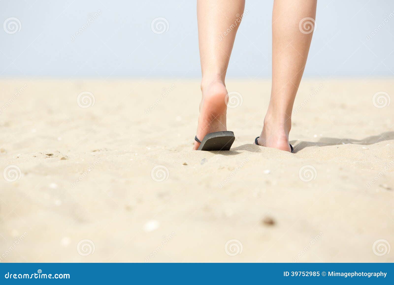 People Walking Away On The Beach