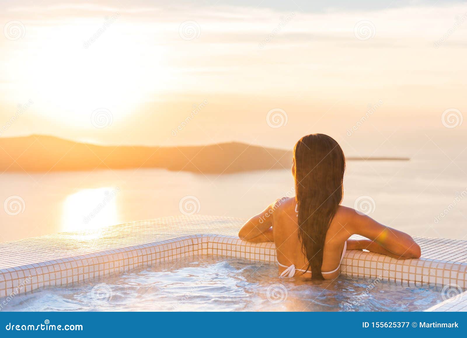 Luxury Spa Wellness Resort Woman Relaxing In Hot Tub Jacuzzi Watching Sunset Over The Aegean Sea