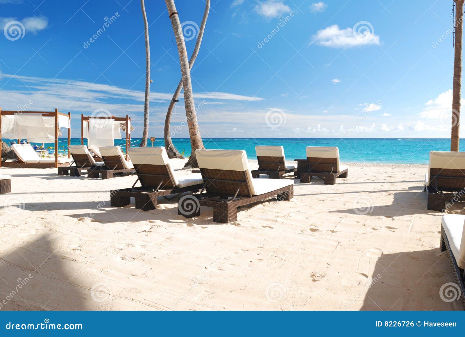 Luxury wooden chaise lounge on beautiful caribbean beach in Dominican 