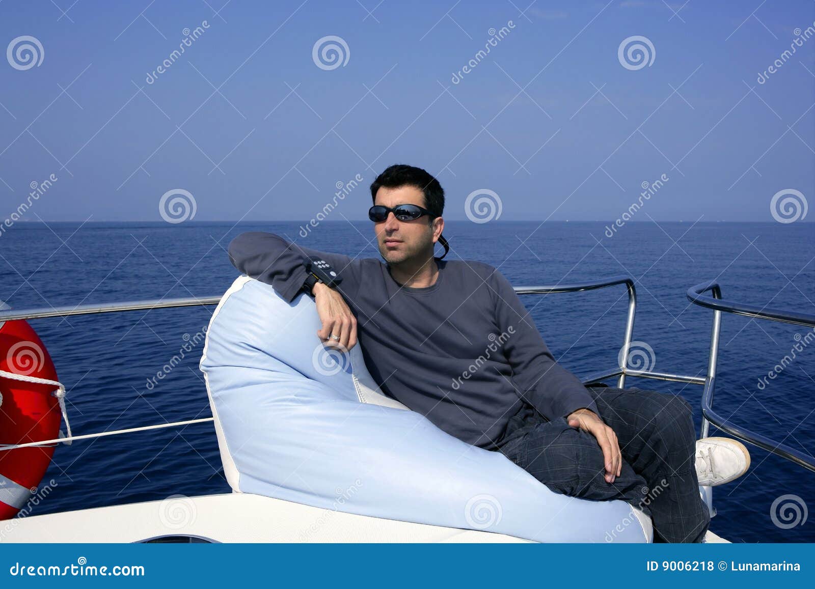 Man On Bow Boat Relaxed On Bean Bag Royalty Free Stock Photos - Image 